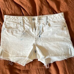 White with blue distressing mid rise slim cut off denim shorts